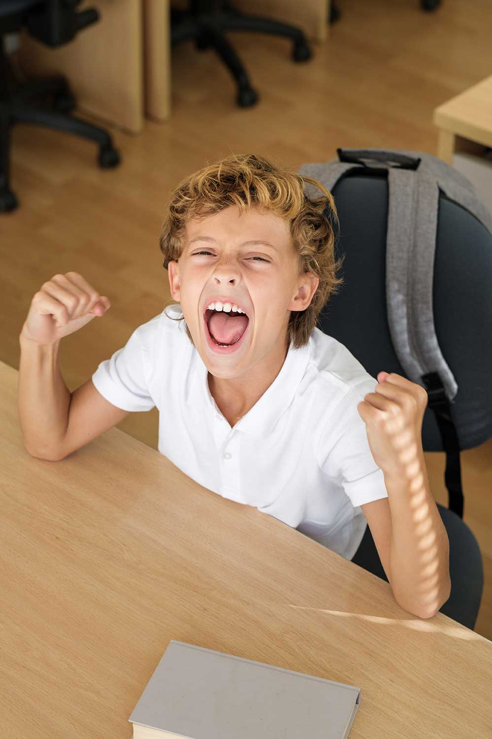 excited-boy-celebrating-victory-in-classroom-2021-10-21-02-31-38-utc